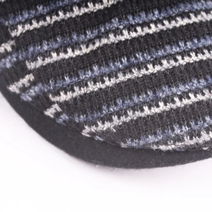 Striped knit flat cap for winter featuring black and blue textured weaving pattern