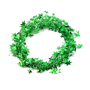 Close-up of flexible green star tinsel garland with metallic glitter finish for Christmas decor
