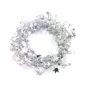 Macro shot of silver Christmas star garland with shiny metallic pentagram fringe details
