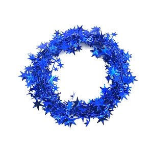 Close-up of bright blue star-shaped tinsel garland for Christmas tree decoration