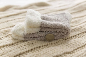 Close-up of thick coral fleece winter socks showcasing fluffy texture and warmth
