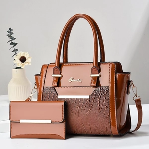 Detail of brown patent leather tote with crocodile texture and matching wallet set