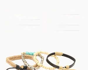 Close-up of vintage multilayer leather bracelet with wooden beads and turquoise feather charm