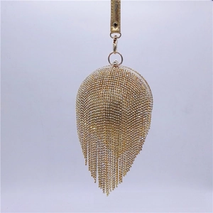 Detail of champagne gold evening bag with rhinestones and long fringe tassels