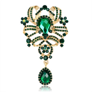 Detail of vintage rose brooch with emerald green crystals and pear-shaped drop pendants