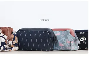 Detail view of four canvas makeup bags featuring flamingo and floral prints with zippers