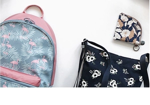 Flat lay view showing flamingo print backpack and floral pattern crossbody bags on white surface