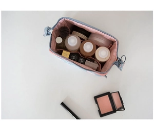 Top view of floral makeup bag with pink lining showing spacious interior storage