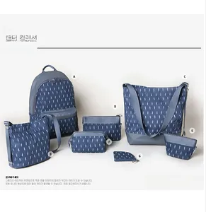 7-piece navy canvas travel bag set with white feather pattern showing various bag sizes