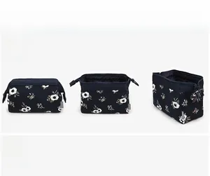 Detail view of navy blue floral makeup bag with metal zipper and spacious interior