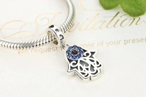 Detailed macro view of S925 sterling silver Hamsa hand charm with blue zircon stones