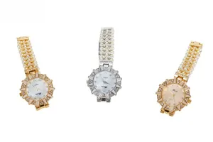 Detail of luxury pearl bracelet watch with crystal bezel and mother of pearl dial