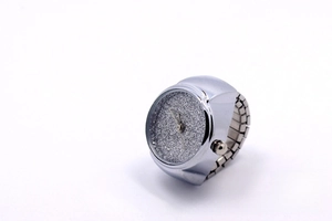 Macro view of silver ring watch with glitter dial and elastic expansion band detail