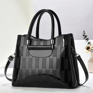 Elegant black patent leather handbag with textured stripes and detachable shoulder strap