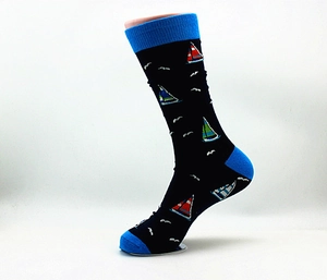 Detail of dark blue crew sock featuring colorful sailboat patterns and light blue toe accents