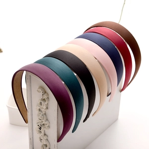 Close-up of matte hairbands in 8 colors displayed on a white vintage stand