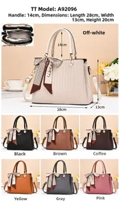 Detailed view of tote bag with wave texture, silk scarf handle, and internal zipper pocket