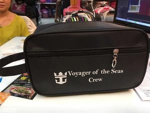Detail view of the black Voyager of the Seas crew toiletry bag with zipper and handle