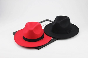 Flat lay of wide brim fedora hats in red and black colors with grosgrain bow ribbon