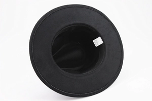 Detail view of the fedora hat interior showing the washing label with size 57 and fabric mix