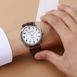 Close-up of elegant quartz watch with brown leather strap and dual time scale display