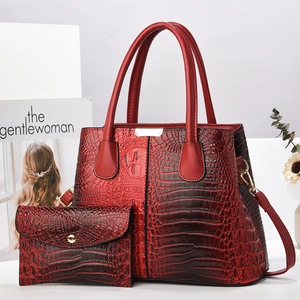 Deep red crocodile embossed tote bag set with matching envelope wallet and gold lock detail