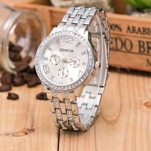 Detail shot of a silver Geneva watch with a diamond dial on a rustic wooden table