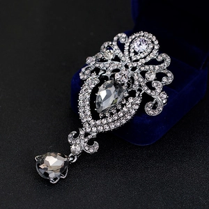 Silver crown brooch with sparkling clear rhinestones and grey teardrop pendants