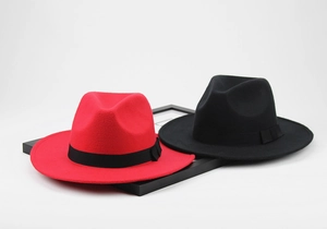 Top view of red and black wool felt fedora hats with wide brims and ribbon bows