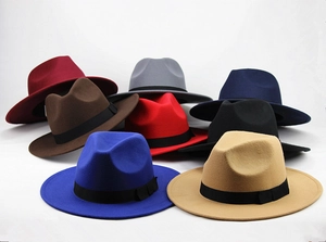 Detailed pile display of various colored wool felt fedora hats with ribbon bands