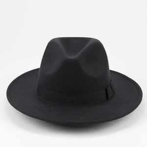 Detail of a black wool felt fedora featuring a classic creased crown and matching ribbon