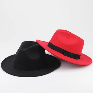 Close-up of classic wool felt fedora hats with satin ribbon bow in red and black