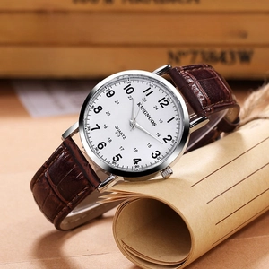 Elegant quartz watch with white dial and brown leather strap on a vintage paper background