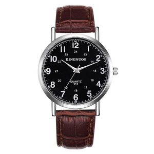Close-up of a brown leather quartz watch with a black dial and silver case detail