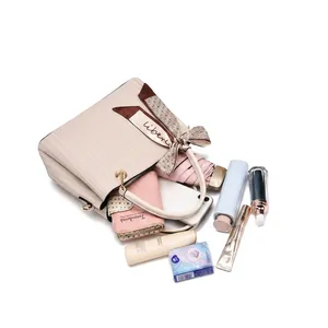 Detail showing high capacity of textured PU leather tote bag with silk scarf handle