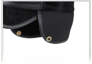 Detail of winter flat top cap featuring warm ear flaps and vintage metal snap buttons