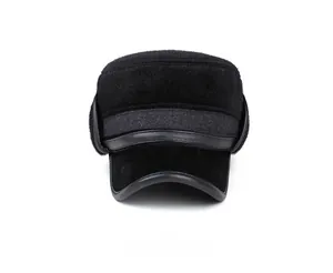 Front view of black faux fur flat top winter hat with earflaps and leather brim trim