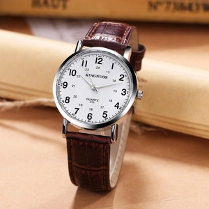 Close-up of elegant quartz watch with white dial and brown crocodile pattern leather strap