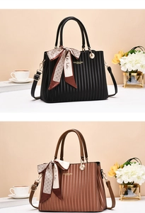 Close-up of dual-tone handbags featuring vertical texture and gold metal hardware