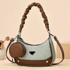 Striped green and white woven hobo bag with brown leather trim and a small round coin purse