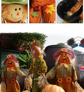 Detailed view of Halloween scarecrow decorations with pumpkin heads and sunflower accents