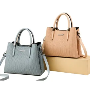 Detailed view of vertical striped texture on chic handbags with Fashion Queen logo