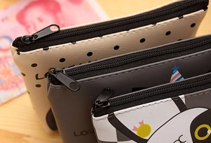Close-up of PU leather coin purses with zipper closure showing stitching details