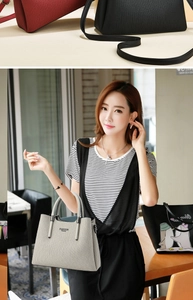 Detail of elegant striped leather tote bag with Fashion Queen logo and shoulder strap