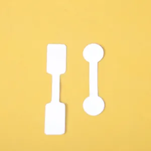 Self-adhesive white jewelry price tags in rectangular and round shapes on yellow background