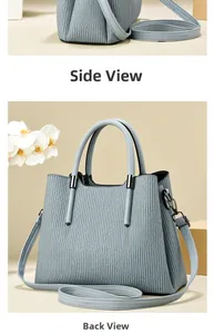 Detailed side and back view of light blue handbag with vertical pleats and detachable strap