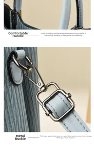Detailed macro view of light blue leather handbag showing reinforced stitching and gold hardware
