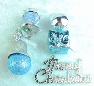 Detailed set of blue and silver Christmas tree ornaments on a white faux fur background