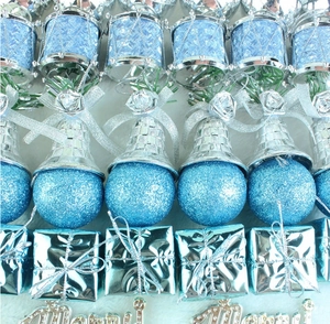 Detail of blue and silver Christmas tree ornaments on white plush texture background