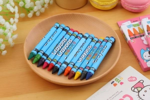 Flat lay of 12-pack washable rotating crayons in a wooden tray with a floral background